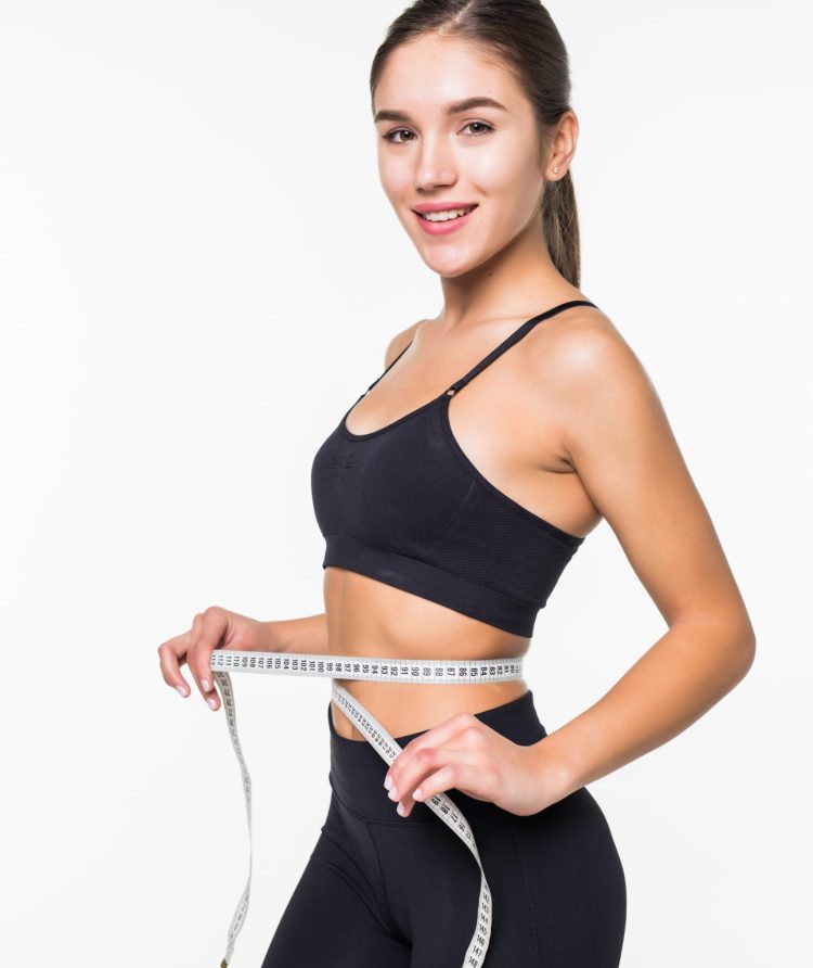 young-fitness-woman-measure-with-tape-her-belly-isolated-white-wall (1)